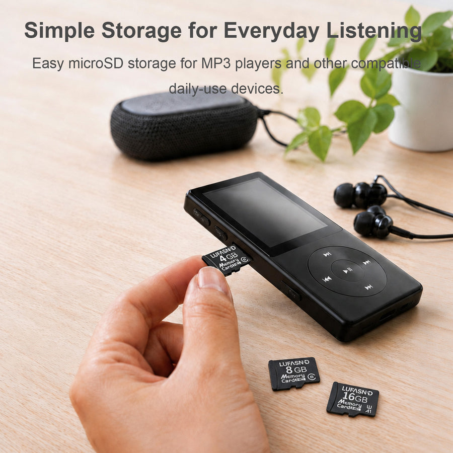 A hand inserting a LUFASND memory card into an MP3 player, with earphones and a speaker on a wooden desk.